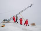 A team of scientists lowering a meteorological tower on the sea ice (Photo: LIanna Nixon)