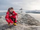 Ocean scientist Sandra Tippenhauer collects rocks and shells from the ice floe, as the MOSAiC floe had large concentrations of sediment from the Lapland Islands