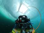 The ROV “The Beast” slowly sinks below the ice to conduct an optics survey of the ice underneath