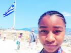 A picture of me in 2014 with the flag of Greece behind me