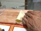 After adding the filling, we fold the dough and press down the edges with a fork