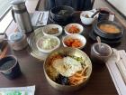 This is Bibimbap (비빔밥)! The vegetables all come in one bowl with an egg on top. There are also several side dishes and soup.  