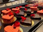 This display window from the month of February with some seasonal Valentines Day giant heart shaped macaroons and rich dark chocolate cake