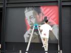 Street artist spray painting mural in Shinjuku, Tokyo