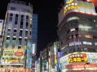 Picture of Shinjuku Crossing at night with business signs in Japanese and English