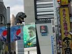 Godzilla's head poking out from the top of Toho Cinema building