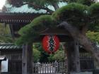 Hasedera Temple's entrance gate has a red lantern with the temple's name and "manji" style symbol on top