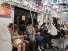 A cute couple falls asleep on the train while holding hands (left)