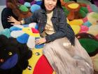Me posing on top of Takashi Murakami's large flower pillows in his souvenir shop in Nakano