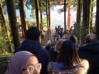 Patiently waiting in line to take photos in front of the Hakone Temple's Heiwa-no-Torii