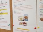 At school, activity sign-ups are posted each week, such as this one for cooking classes at a local family's home
