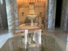 This bathroom is a recreation of ancient Greek soaking bathtubs that were sunk sometimes as deep as 6 feet into the ground