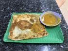 This is an Indian-style dish called "roti prata"--it is a stuffed flatbread with a side of curry