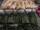 One type of "tamal" is wrapped in banana leaf and the other is wrapped in corn husk