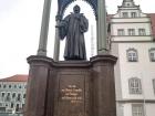 Statue of Martin Luther holding a book that has quotes he has written