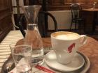 This is how all melanges or Viennese cappuccinos are served in Vienna, with a class of water and a sugar packet