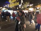 A picture of me posing in front of the Merry Christmas sign, holding my mug of Glühwein! 
