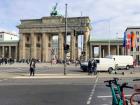 The Brandenburg Gate, a famous monument in Berlin, with scooters visible in front