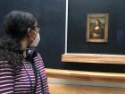 Getting my close-up with the Mona Lisa at the Louvre Museum!