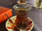 This is Jordanian tea, or "shay" in Arabic, it is drunk during every meal and served at cafes everywhere