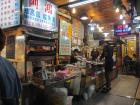 The stall on the corner sells a variety of rice and noodle dishes.