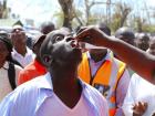 An adult is given the cholera vaccine by a health worker