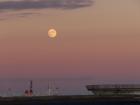 A beautiful moon rising at the port despite the desperate circumstances