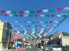 A typical Tlaxcala street view with some different modes of transportation visible