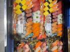 Here are large sushi platters for sale with a bunch of different types of fish in them