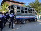 A typical Thai school bus unloading marching band students for a parade