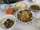 Lunch with teachers: (left to right) snails from the rice fields, a huge dish of som tam and some beef stew