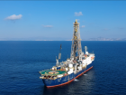 The JOIDES Resolution at the first drilling site of Expedition 398, with the Cyclades Islands in the background