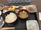 Japanese breakfast: eggs, little fish, pickled plum, rice and salmon 