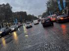 Cars travelling down the street on a rainy day