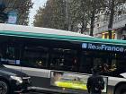 A bus taking passengers across Paris