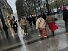 People walking down the "Champs-Elysees", even in the rain.