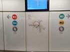 Here is a detailed map of the Copenhagen Metro System, accompanied by an electronic metro schedule right above it