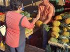 My host mom picking out the best pineapples at the local market