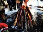 A bonfire that is being started with seasonal yule logs, a tradition that started with the pagan tribe rituals
