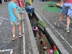 Kids in Freiburg have a tradition where they race little plastic boats through homemade obstacles using the city's water canals