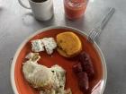 This is desayuno típico (typical breakfast) made of chorizo (spicy sausage), queso de campo (countryside cheese), eggs and tortillas; Panamanian tortillas are much thicker than Mexican tortillas