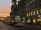 One of the many trams in Bern, with a colorful sunset in the background