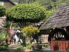 An old well and statue of an Austro-German Settler in the plaza of Pozuzo
