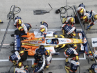 A shot of a pit crew. Look at how many people are working together to go as fast as possible. Look closely, you’ll see the sub-teams working on one part (like changing each tire)