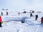 It takes a whole team to pull cables into place (Colton Hill, IceCube/NSF)