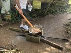 A family member preparing chicarrones-- fried pork belly!