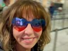 Larkin is enjoying her new pair of heart glasses as she enters the check in line at airport