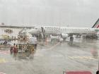 Waiting inside the Paris airport to board the plane during the rain.