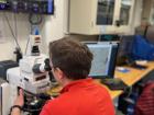 Walter examining a sediment sample through the microscope
