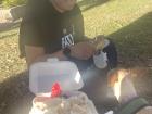 Sitting down in the park, enjoying Merengón with my neighbor, Andres, and Butler